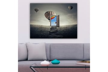 Lerretsbilde 70x100 cm - Åpen dør som fører til en fargerik himmel med varmluftsballonger som svever over et goldt landskap - Grå / Beige / Rød - Interiør - Maleri & posters - Lerretsbilder
