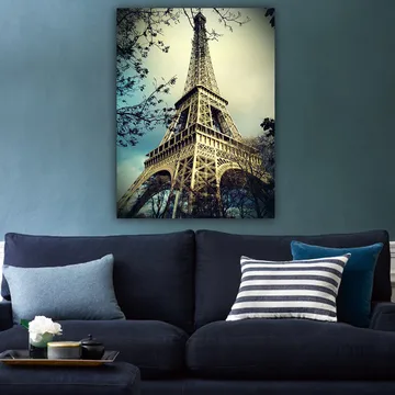 Lerretsbilde 70x100 cm - Eiffeltårnet i Paris, fotografert fra lav vinkel med omkringliggende tregrener - Grå / Beige / Blå - Interiør - Maleri & posters - Lerretsbilder