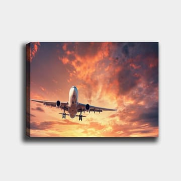 Lerretsbilde 70x100 cm - Et fly som lander mot en dramatisk solnedgang med fargerike skyer - Oransje / Lilla / Blå - Interiør - Maleri & posters - Lerretsbilder