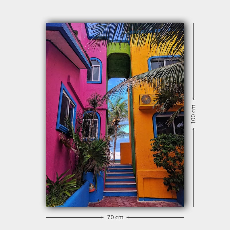 Lerretsbilde 70x100 cm - Fargerik arkitektur med en trapp som fører gjennom en livlig smug - Rosa / Gul / Blå - Interiør - Maleri & posters - Lerretsbilder