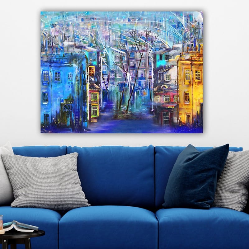 Lerretsbilde 70x100 cm - Fargerik bybilde med hus i forskjellige nyanser og trær under en regnfull himmel - Blå / Gul / Lilla - Interiør - Maleri & posters - Lerretsbilder