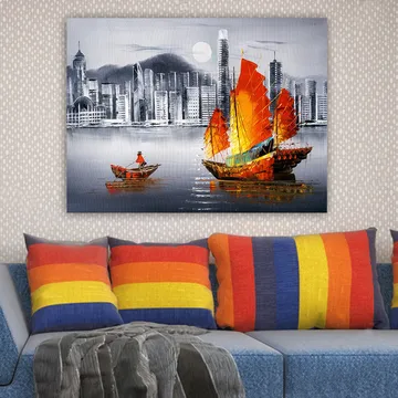 Lerretsbilde 70x100 cm - Fargerik seilbåt med røde seil på en speilblank vannflate, omgitt av et moderne bybilde - Rød / Oransje / Blå - Interiør - Maleri & posters - Lerretsbilder