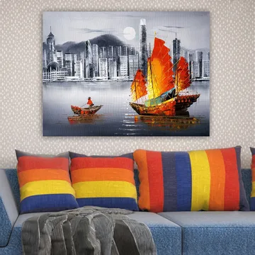 Lerretsbilde 70x100 cm - Fargerik seilbåt med røde seil på en speilblank vannflate, omgitt av et moderne bybilde - Rød / Oransje / Blå - Interiør - Maleri & posters - Lerretsbilder