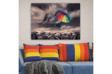 Lerretsbilde 70x100 cm - Fargerik paraply svever over en samling grå paraplyer under en dramatisk overskyet himmel - Regnbuefarger / Grå - Interiør - Maleri & posters - Lerretsbilder