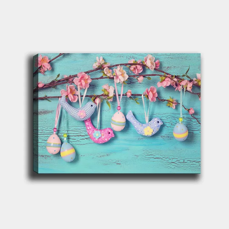Lerretsbilde 70x100 cm - Fargerike fugler og egg som henger på en gren med blomster, Blå / Rosa / Grønn