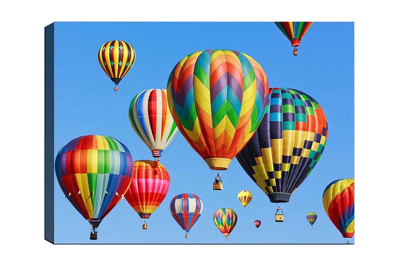 Lerretsbilde 70x100 cm - Flere fargerike varmluftsballonger som svever på en klar blå himmel, Rød / Grønn / Gul