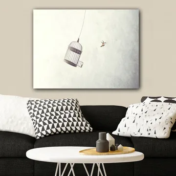 Lerretsbilde 70x100 cm - Fuglebur hengende i luften med en fugl som flyr i nærheten - Grå / Svart / Hvit - Interiør - Maleri & posters - Lerretsbilder