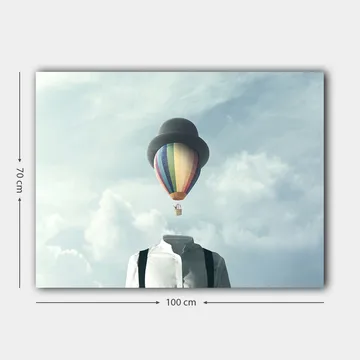 Lerretsbilde 70x100 cm - Hodeløs mann i hvit skjorte og svart hatt, med en fargerik varmluftsballong som svever over seg - Hvit / Svart / Regnbue - Interiør - Maleri & posters - Lerretsbilder