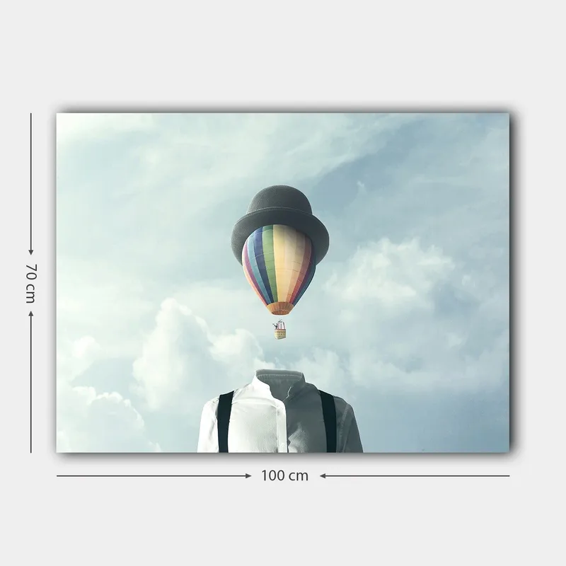 Lerretsbilde 70x100 cm - Hodeløs mann i hvit skjorte og svart hatt, med en fargerik varmluftsballong som svever over seg - Hvit / Svart / Regnbue - Interiør - Maleri & posters - Lerretsbilder
