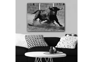 Lerretsbilde 70x100 cm - Kraftig okse i bevegelse, fanget i et øyeblikk av intensitet og styrke - Svart / Grå - Interiør - Maleri & posters - Lerretsbilder