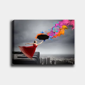 Lerretsbilde 70x100 cm - Kvinne i rød kjole står på en kant og holder en paraply, mens fargerike malingsstråler spruter ut fra den - Rød / Svart / Oransje - Interiør - Maleri & posters - Lerretsbilder