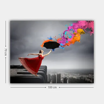 Lerretsbilde 70x100 cm - Kvinne i rød kjole står på en kant og holder en paraply, mens fargerike malingsstråler spruter ut fra den - Rød / Svart / Oransje - Interiør - Maleri & posters - Lerretsbilder