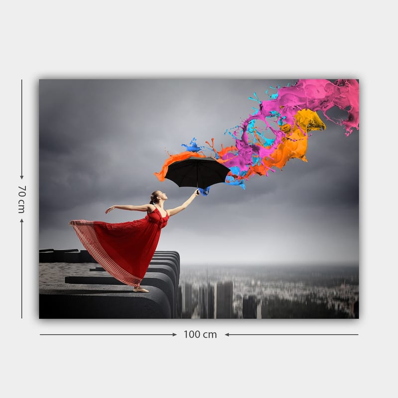 Lerretsbilde 70x100 cm - Kvinne i rød kjole står på en kant og holder en paraply, mens fargerike malingsstråler spruter ut fra den - Rød / Svart / Oransje - Interiør - Maleri & posters - Lerretsbilder