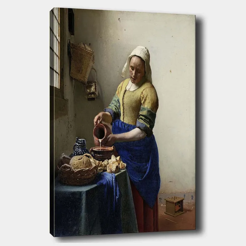 Lerretsbilde 70x100 cm - Kvinne som heller melk i en bolle på et lyst kjøkken, Blå / Gul / Brun