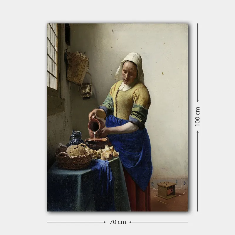 Lerretsbilde 70x100 cm - Kvinne som heller melk i en bolle på et lyst kjøkken - Blå / Gul / Brun - Interiør - Maleri & posters - Lerretsbilder