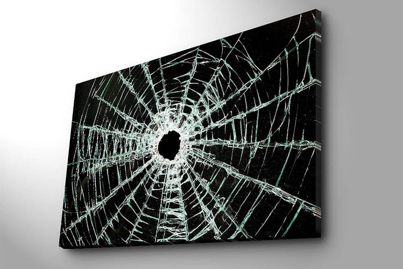 Lerretsbilde 70x100 cm - Nærbilde av en sprukket glassrute med et hull i midten og sprekker som strekker seg utover - Svart / Gjennomsiktig - Interiør - Maleri & posters - Lerretsbilder
