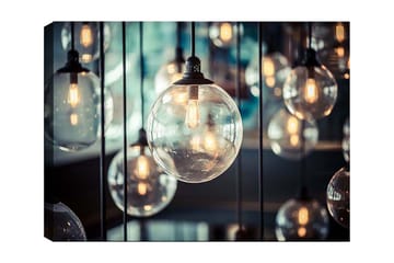 Lerretsbilde 70x100 cm - Samling av hengende lyspærer i forskjellige størrelser som skaper en atmosfære av varme og lys - Klar / Svart / Gull - Interiør - Maleri & posters - Lerretsbilder