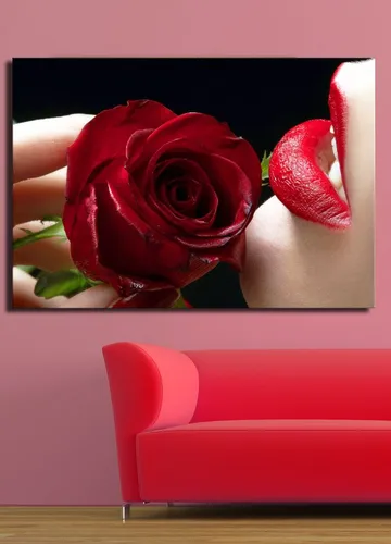 Lerretsbilde 70x100 cm - Sensuell nærbilde av en rose holdt tett inntil en leppe med rød leppestift - Rød / Grønn - Interiør - Maleri & posters - Lerretsbilder