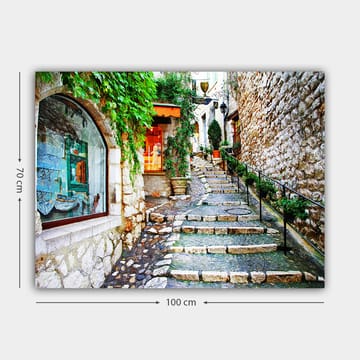 Lerretsbilde 70x100 cm - Sjarmerende smug med steiner og grøntområder som fører oppover, omgitt av historiske bygninger - Grønn / Beige / Oransje - Interiør - Maleri & posters - Lerretsbilder