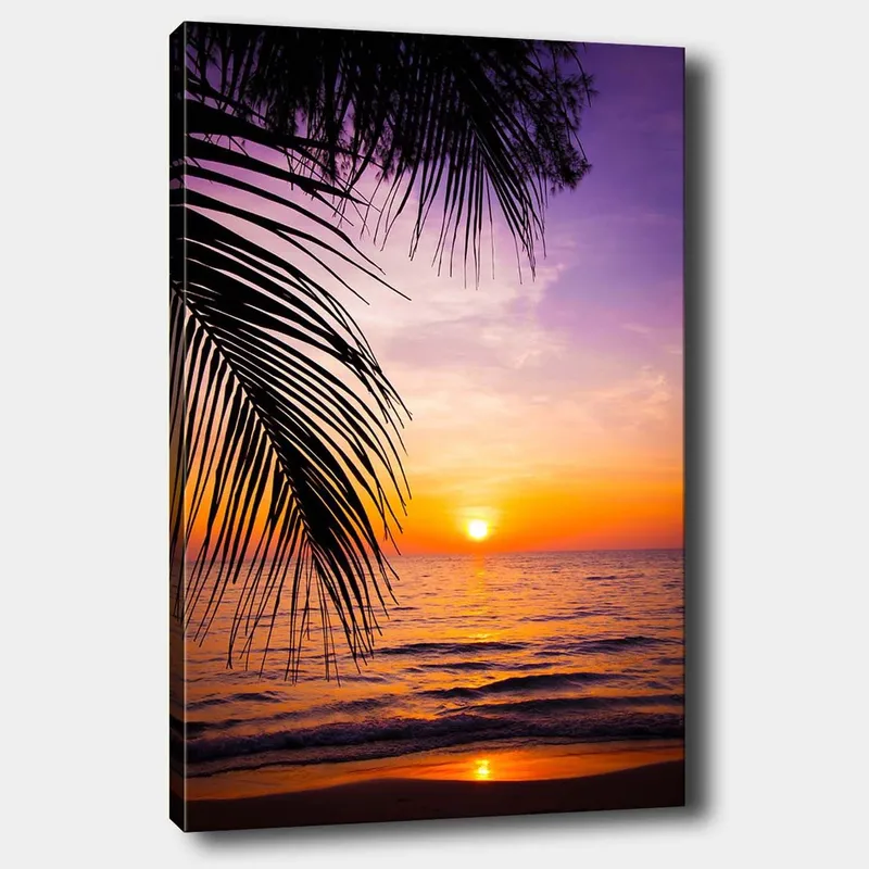 Lerretsbilde 70x100 cm - Solnedgang over havet med palmer i forgrunnen, Lilla / Oransje / Gul