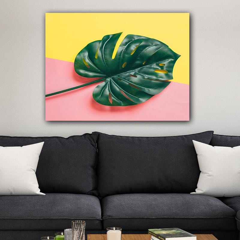 Lerretsbilde 70x100 cm - Stort, grønt monsterablad mot en fargerik bakgrunn av gult og rosa - Grønn / Gul / Rosa - Interiør - Maleri & posters - Lerretsbilder