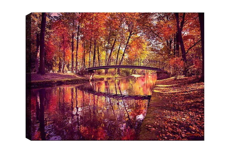 Lerretsbilde 70x100 cm - Vakker høstscene med en bro som spenner over en speilblank vannoverflate omgitt av fargerike trær, Oransje / Rød / Gul