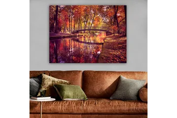 Lerretsbilde 70x100 cm - Vakker høstscene med en bro som spenner over en speilblank vannoverflate omgitt av fargerike trær - Oransje / Rød / Gul - Interiør - Maleri & posters - Lerretsbilder