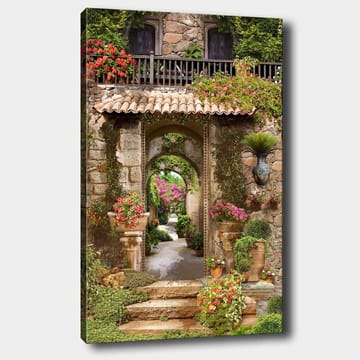 Lerretsbilde 70x100 cm - Vakker og frodig hage med blomsteroppsatser og en steinbue som fører inn til en løvrik gangvei - Grønn / Rosa / Beige - Interiør - Maleri & posters - Lerretsbilder