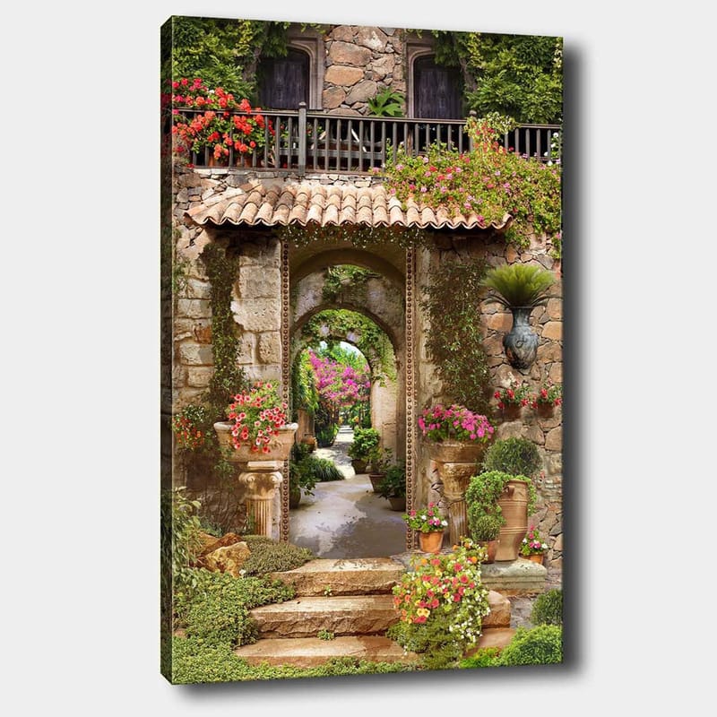 Lerretsbilde 70x100 cm - Vakker og frodig hage med blomsteroppsatser og en steinbue som fører inn til en løvrik gangvei, Grønn / Rosa / Beige