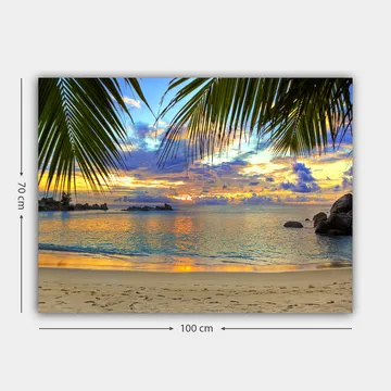 Lerretsbilde 70x100 cm - Vakker solnedgang over en strand med palmer som rammer inn motivet - Blå / Oransje / Grønn - Interiør - Maleri & posters - Lerretsbilder