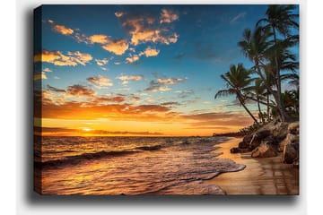 Lerretsbilde 70x100 cm - Vakker solnedgang på en strand med palmer og myke bølger som ruller nedover sanden - Oransje / Blå / Beige - Interiør - Maleri & posters - Lerretsbilder