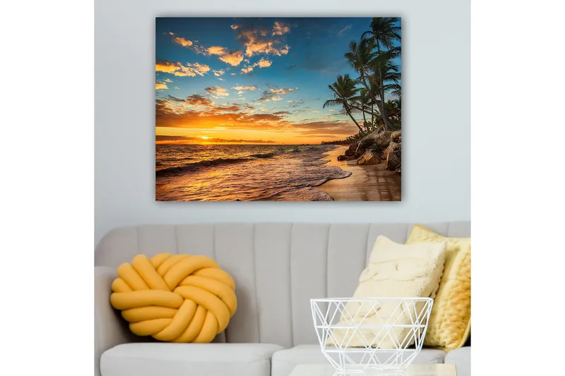 Lerretsbilde 70x100 cm - Vakker solnedgang på en strand med palmer og myke bølger som ruller nedover sanden, Oransje / Blå / Beige
