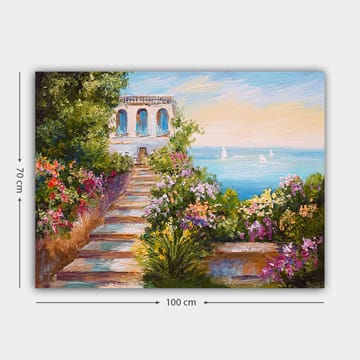 Lerretsbilde 70x100 cm - Vakker trapp omgitt av fargerike blomster som fører ned til havet og en bygning med blå vinduer - Grønn / Rosa / Blå - Interiør - Maleri & posters - Lerretsbilder