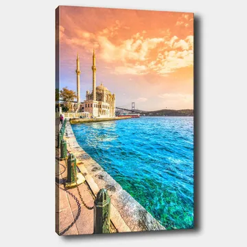 Lerretsbilde 70x100 cm - Vakker utsikt over en moské ved vannet med en bro i bakgrunnen under en fargerik himmel - Blå / Oransje / Beige - Interiør - Maleri & posters - Lerretsbilder