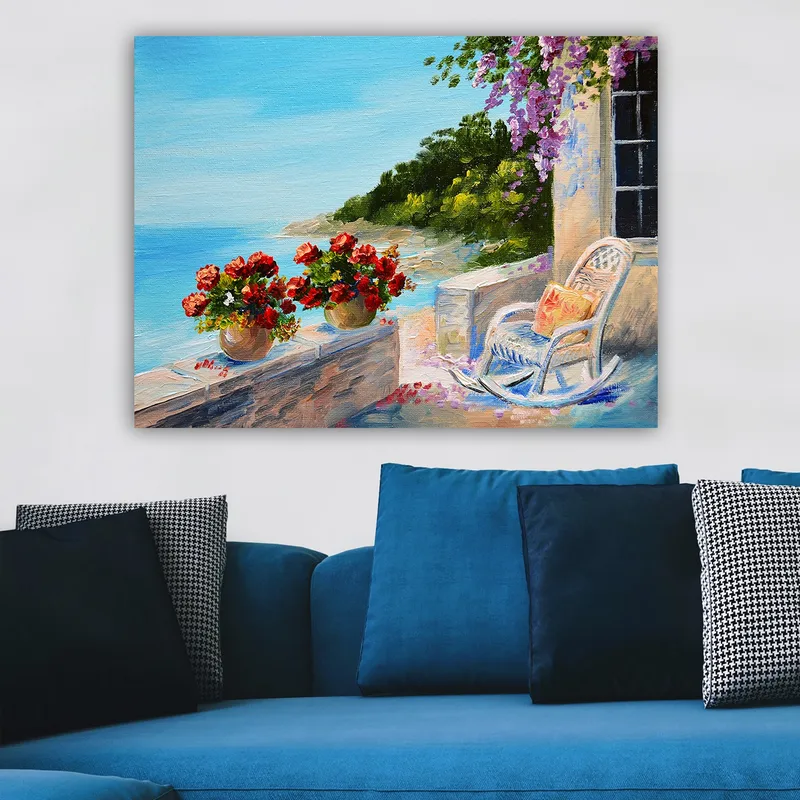 Lerretsbilde 70x100 cm - Vakker utsikt over havet med blomster i potter og en stol på en terrasse - Blå / Grønn / Rød - Interiør - Maleri & posters - Lerretsbilder