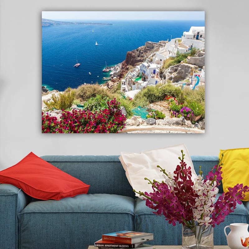 Lerretsbilde 70x100 cm - Vakker utsikt over Santorini med hvite hus og blomster som pryder klippene ved havet - Blå / Hvit / Grønn - Interiør - Maleri & posters - Lerretsbilder