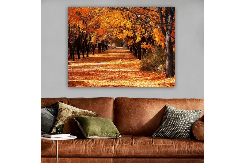 Lerretsbilde 70x100 cm - Vakkert høstmotiv med trær i sterke oransje og gule nyanser som skaper en innbydende gangvei dekket av falne blader - Oransje / Gul / Brun - Interiør - Maleri & posters - Lerretsbilder