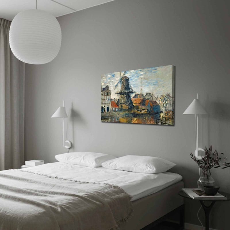 Lerretsbilde 70x100 cm - Vindmølle ved vann omgitt av pittoreske bygninger, Blå / Grønn / Oransje