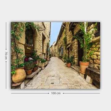 Lerretsbilde 70x100 cm - Pittoresk smug i en gammel landsby med steinhus og blomsterpotter - Beige / Grønn / Terrakotta - Interiør - Maleri & posters - Lerretsbilder