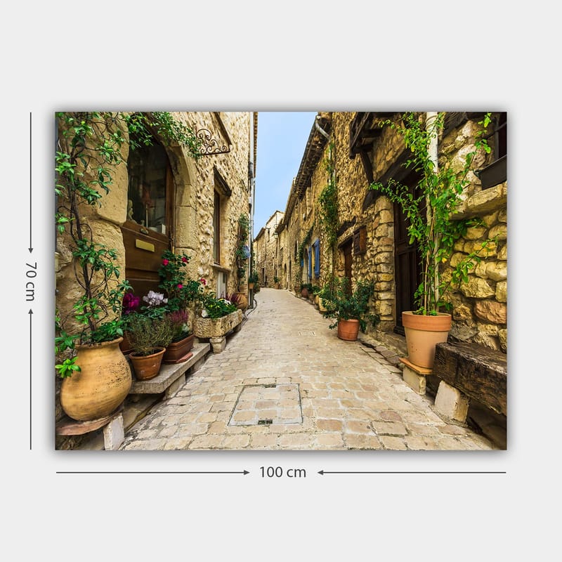 Lerretsbilde 70x100 cm - Pittoresk smug i en gammel landsby med steinhus og blomsterpotter - Beige / Grønn / Terrakotta - Interiør - Maleri & posters - Lerretsbilder