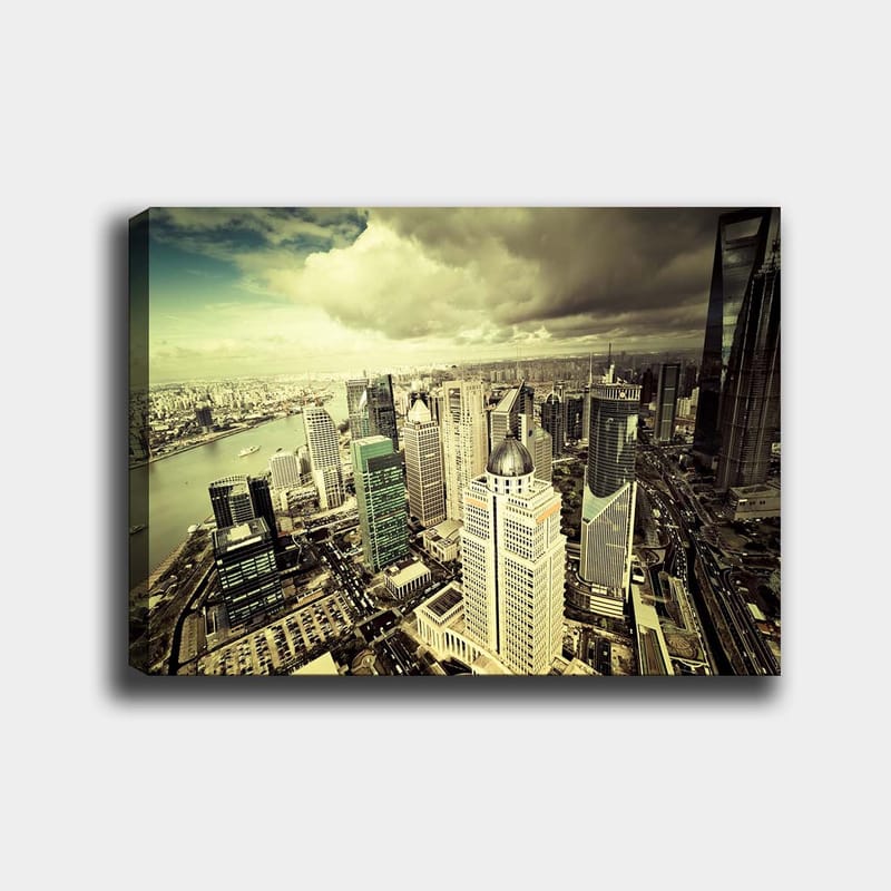 Lerretsbilde 70x100 cm - Panoramautsikt over en moderne by med høye skyskrapere og en elv som renner gjennom landskapet, Grønn / Grå / Beige