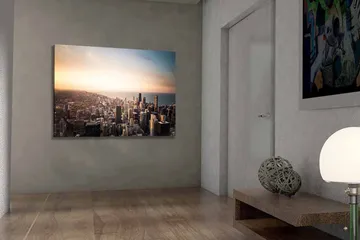 Lerretsbilde 70x100 cm - Panoramautsikt over en by med høye skyskrapere og en solnedgang som skaper en dramatisk atmosfære - Blå / Oransje / Grå - Interiør - Maleri & posters - Lerretsbilder