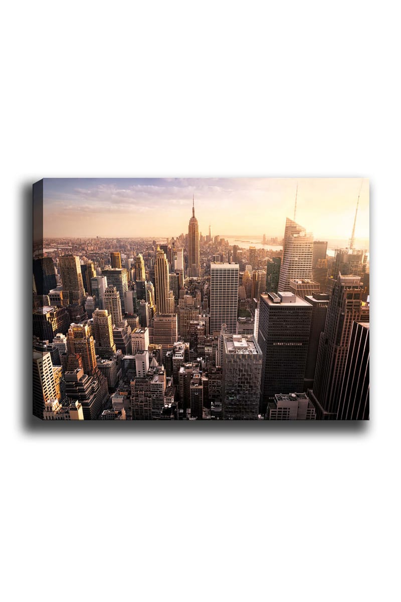Lerretsbilde 70x100 cm - Panoramautsikt over en by med skyskrapere og den ikoniske Empire State Building ved solnedgang, Gull / Grå / Blå