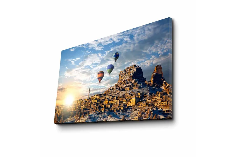 Lerretsbilde 70x45 cm - Fargerike varmluftsballonger svever over en pittoresk fjellandsby ved soloppgang - Gull / Blå / Oransje - Interiør - Maleri & posters - Lerretsbilder