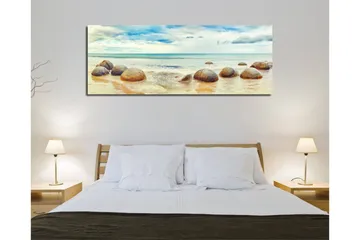 Lerretsbilde 80x30 cm - Runde steiner på en strand med hav og himmel i bakgrunnen - Blå / Beige / Grå - Interiør - Maleri & posters - Lerretsbilder