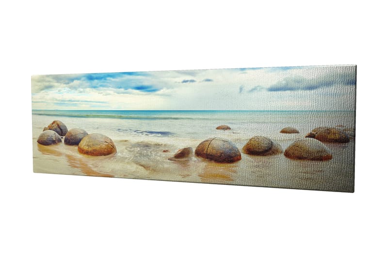 Lerretsbilde 80x30 cm - Runde steiner på en strand med hav og himmel i bakgrunnen, Blå / Beige / Grå