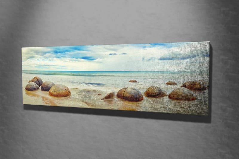 Lerretsbilde 80x30 cm - Runde steiner på en strand med hav og himmel i bakgrunnen - Blå / Beige / Grå - Interiør - Maleri & posters - Lerretsbilder