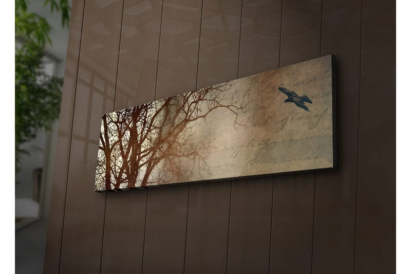 Lerretsbilde med LED-belysning 30x90 cm - Silhuett av et tre med en fugl i flukt mot en mykt tonet bakgrunn, Mørk brun / Beige / Svart