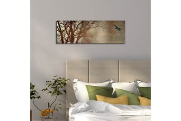 Lerretsbilde med LED-belysning 30x90 cm - Silhuett av et tre med en fugl i flukt mot en mykt tonet bakgrunn - Mørk brun / Beige / Svart - Interiør - Maleri & posters - Lerretsbilder
