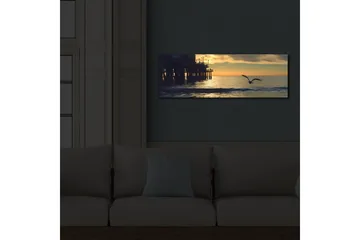 Lerretsbilde med LED-belysning 30x90 cm - Solnedgang over havet med en fugl i flukt - Oransje / Blå / Grå - Interiør - Maleri & posters - Lerretsbilder